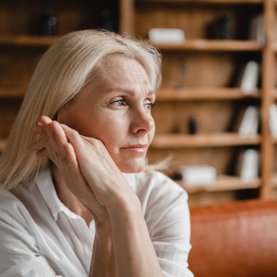 Frau schaut nachdenklich zur Seite